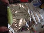 Wrap corns w/ husks in tin foil